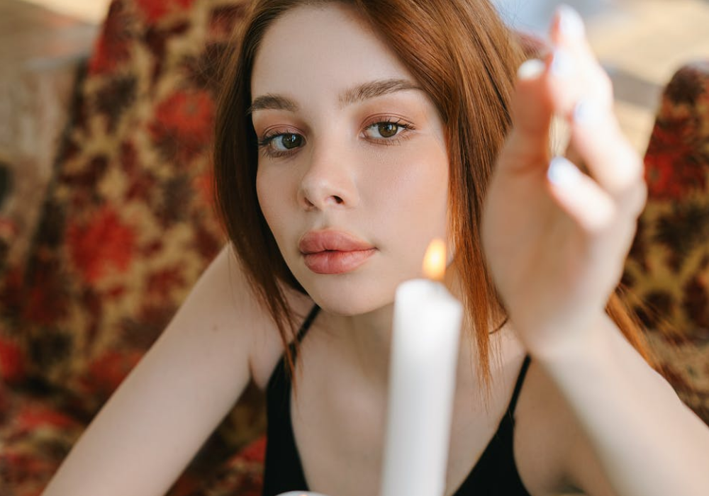 imagem mostra mulher e uma vela branca
