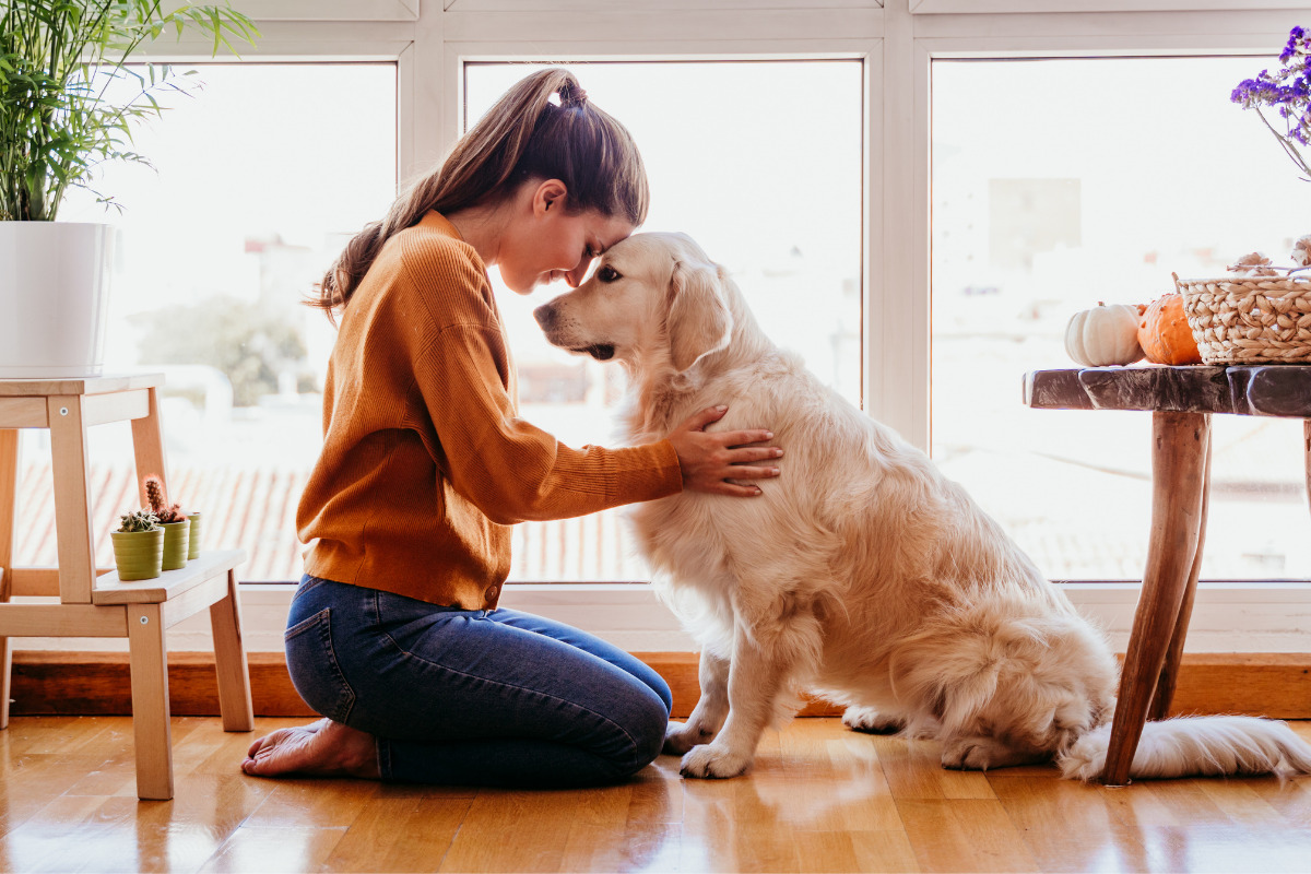Mulher em oração ao lado de seu cachorro